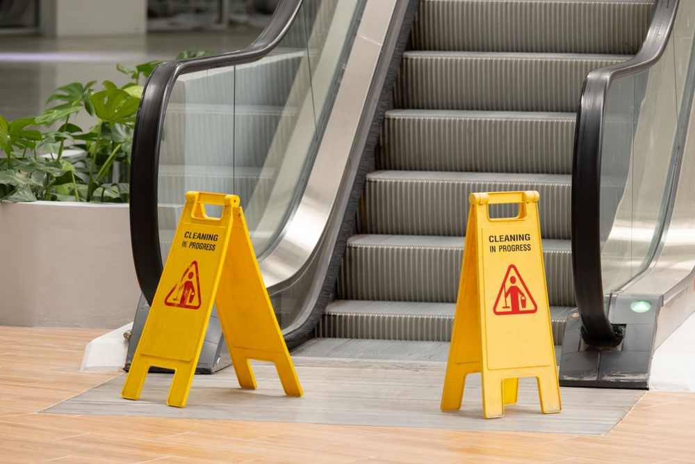 Caution signs placed at the foot of an escalator