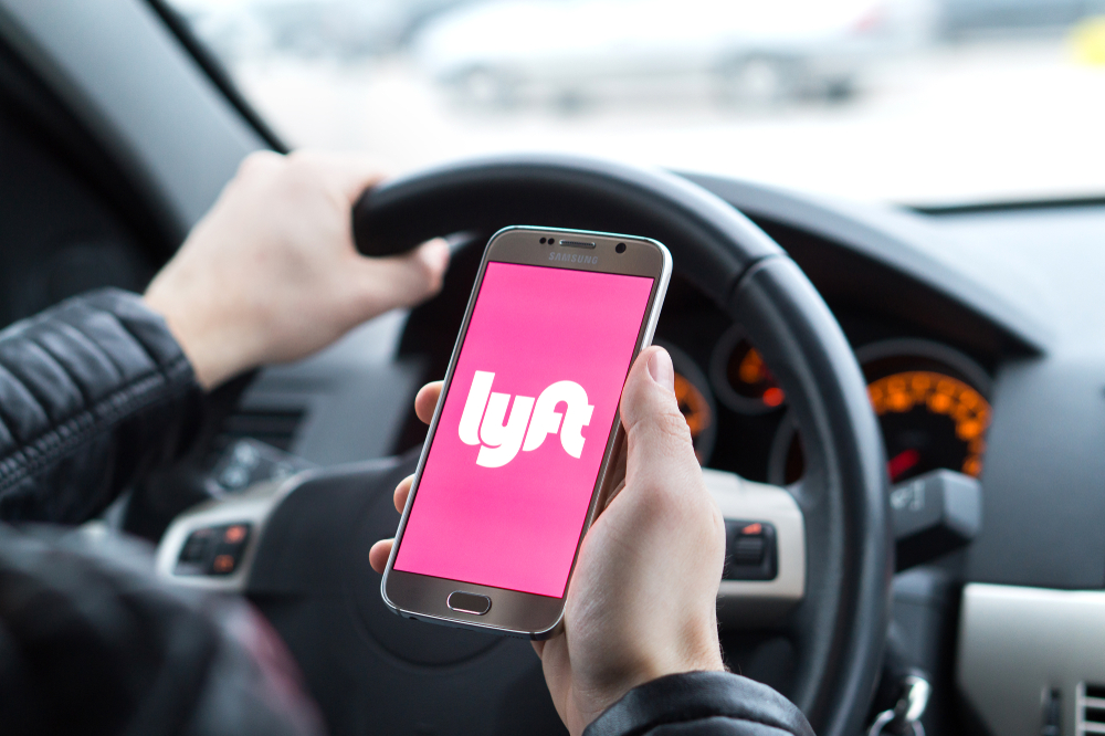 Close up of driver with Lyft logo on cell phone