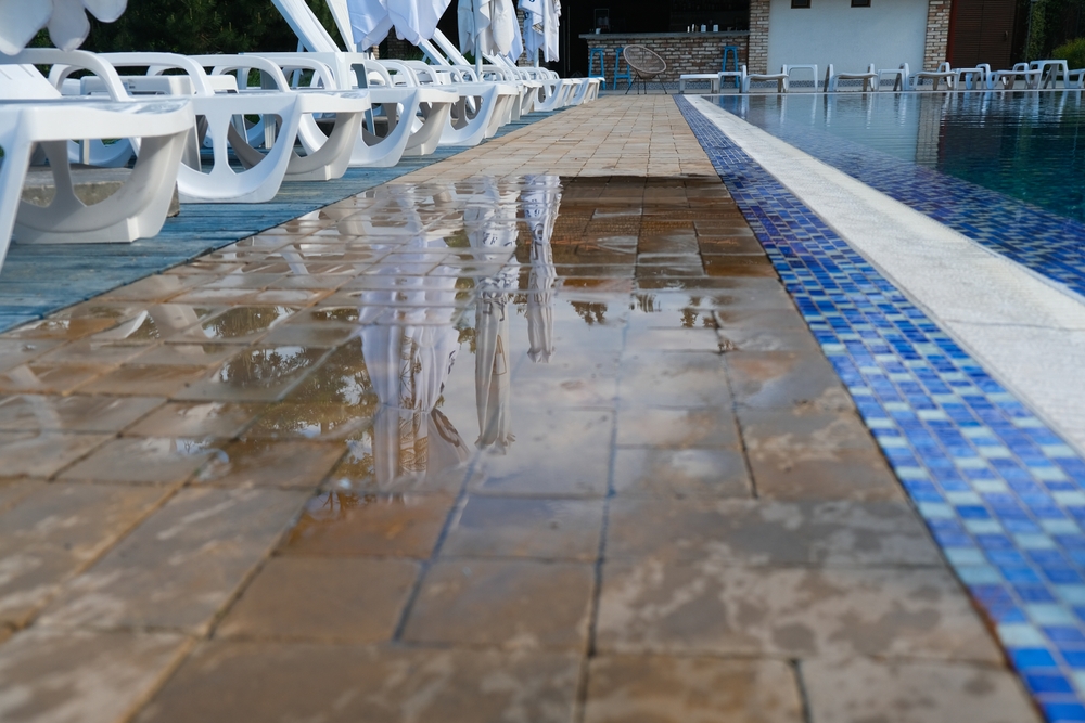 Unmarked wet path next to swimming pool